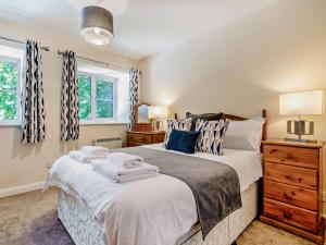 a bedroom with a bed with towels on it at 4 Bed in Dorchester oc-92413 in Frome Vauchurch