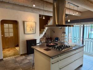 a kitchen with a stove top oven in a room at Mas de la Meï in Cavaillon