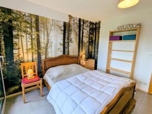 a bedroom with a bed and a wall with trees at Chalet Mon Beau Sapin lisière de Forêt - Vue montagne - Gerardmer in Anould