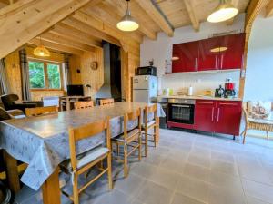 a kitchen with a large wooden table and chairs at Chalet Mon Beau Sapin lisière de Forêt - Vue montagne - Gerardmer in Anould