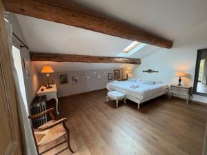 a large bedroom with a bed and a desk and a window at Mas de la Meï in Cavaillon +55 photos