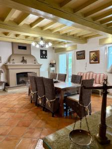a living room with a table and chairs and a fireplace at Mas de la Meï in Cavaillon