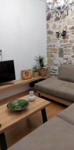 a living room with a table and a couch at Angel's Luxury Studio in Olympiada +14 photos