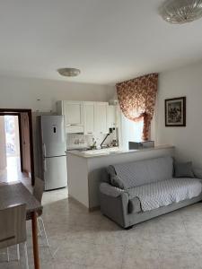 a living room with a couch and a kitchen at Siderea House in Chioggia