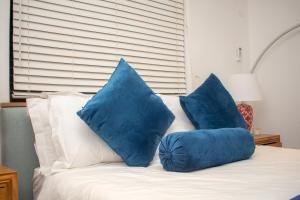 two blue pillows sitting on top of a bed at Nkandla Resort in Bulawayo
