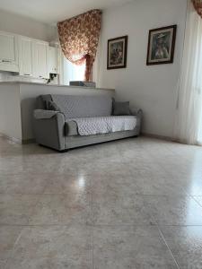 a living room with a couch and a tile floor at Siderea House in Chioggia +34 photos