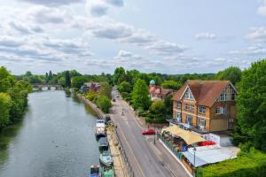 a view of a river in a town with a building at Uno Thames Hotel -Reopened Brand New Again -FREE PARKING in Maidenhead