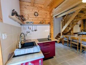 a kitchen with a sink and a wooden ceiling at Chalet Mon Beau Sapin lisière de Forêt - Vue montagne - Gerardmer in Anould