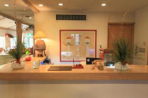 an office with a desk with two potted plants on it at Resort Hotel Corte Largo Izu Kogen in Ito +106 photos