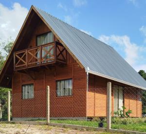 a large wooden house with a metal roof at Chalé Azaléia in Campo Alegre