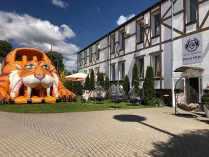 a large tiger statue in front of a building at Pensjonat Nowy Młyn in Kostrzyn nad Odrą
