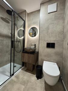 a bathroom with a toilet and a sink and a shower at CUBE Alpine Stay in Bürs +23 photos