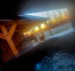 a wooden picnic table sitting next to a swimming pool at Zacisze Częstkowo in Częstkowo