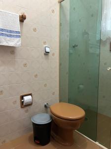 a bathroom with a toilet and a glass shower at Fascinação Café Hotel in Cunha +90 photos