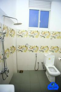 a bathroom with a shower and a toilet and a window at NAT City Ella in Ella +31 photos