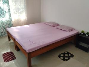 a bed in a room with a purple mattress at Pranalay HS Warm and Cozy in Tezpur