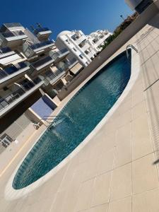a swimming pool on the side of a building at El Campello Beach Sea in El Campello