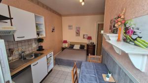 a kitchen with a sink and a table in a room at Le sélect in Néris-les-Bains