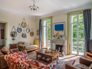 a living room with a couch and a fireplace at Beautiful large stylish villa centrally located in Pons in Pons