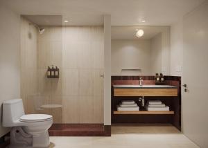 a bathroom with a toilet and a sink at All Inn Hotel in Denver +17 photos