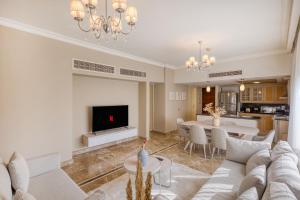 a living room with a couch and a dining room at El Safwa Resort New Cairo in Cairo