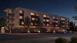 a building with an illuminated sign on the side of it at All Inn Hotel in Denver
