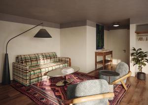 a living room with a couch and a table at All Inn Hotel in Denver