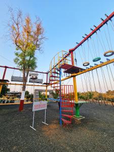 a roller coaster in a park with a sign at The Crystal Woods Resort in Mendarda