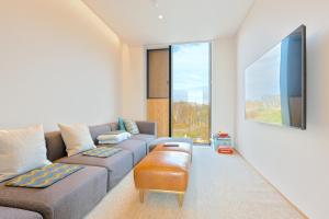 a living room with a couch and a table at Villa Mori - Odin Hills in Kutchan