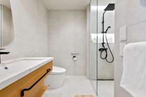 a bathroom with a shower and a toilet and a sink at Villa Mori - Odin Hills in Kutchan +29 photos
