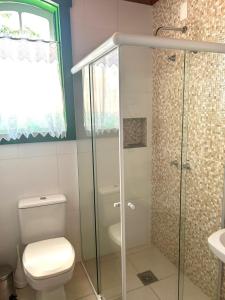 a bathroom with a toilet and a glass shower at Solar de Amelia in Tiradentes +52 photos