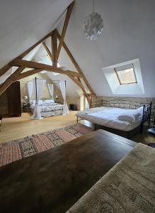 a bedroom with two beds in a attic at Sweet Pea Cottage in Donzy