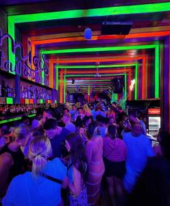a crowd of people at a party in a bar at AMIGOS Hostel El Nido in El Nido