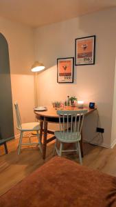 a dining room with a table and two chairs at 70's Inspired 1 Bed flat in Knebworth +4 photos
