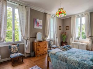 a bedroom with a bed and two chairs at Beautiful large stylish villa centrally located in Pons in Pons +126 photos