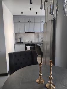 a kitchen with a table with a chair and a refrigerator at Balka-centr Tiraspol in Tiraspol