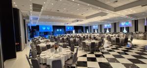 a large banquet hall with tables and chairs in it at Savoia Hotel Regency in Bologna +92 photos