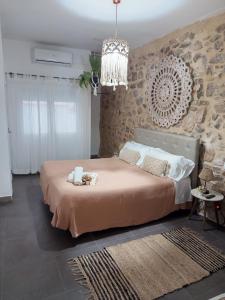 a bedroom with a large bed and a chandelier at Ananda Beach Rooms - Castillo de Peñiscola in Peniscola