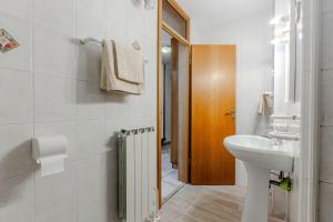 a white bathroom with a sink and a toilet at Apartments Mija in Krotica +112 photos