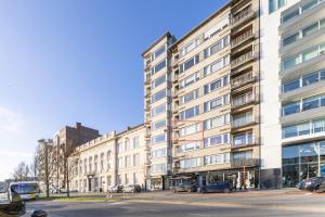 a large white building with cars parked in front of it at Mercator 0301 in Ostend