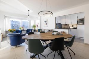 a kitchen and dining room with a table and chairs at Mercator 0301 in Ostend