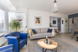 a living room with a couch and a table at Mercator 0301 in Ostend