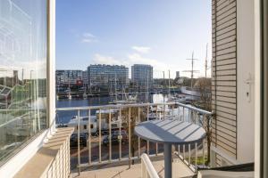 a balcony with a table and a view of a marina at Mercator 0301 in Ostend +10 photos
