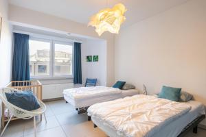 a bedroom with two beds and a window at Mercator 0301 in Ostend