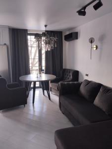 a living room with a couch and a table at Balka-centr Tiraspol in Tiraspol +2 photos