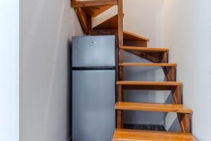 a refrigerator in a room with a staircase at Apartments Mija in Krotica