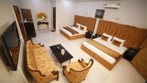 a view of a room with two beds and a table at Four Squares by WIH in Karachi