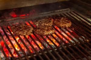 a group of hamburgers cooking on a grill at Maritim Fjordhotell in Flekkefjord