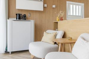 a living room with two chairs and a table at Lua Beach House in Zandvoort