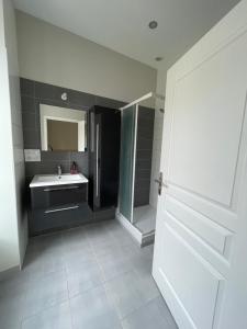 a bathroom with a sink and a mirror at Maison de ville in Lannion